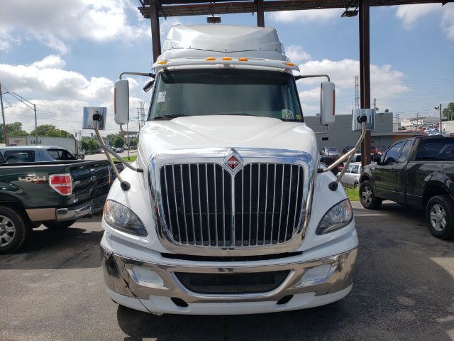 Front view of a 2015 International PROSTAR sleeper cab truck showing large chrome grille, headlights, and bumper.