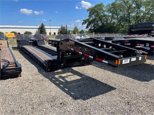 2033 Fontaine 55 ton steel lowboy trailer with flat, low deck showing black frame and multiple axles in a gravel lot.