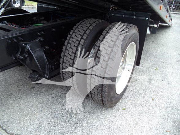 Freightliner BUSINESS CLASS M2 106 rear dual wheels showing tire tread and wheel wells.