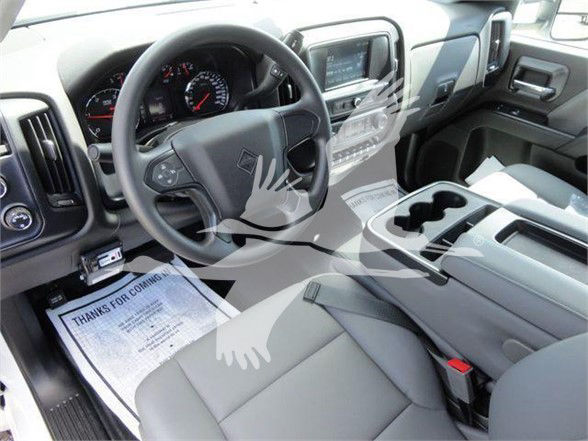 Interior of a 2023 International CV dump truck showing steering wheel, dashboard, center console, and seats.