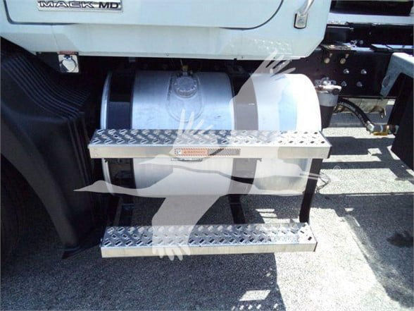 Mack MD series truck showing metal diamond-plate steps attached to the side of the cab.