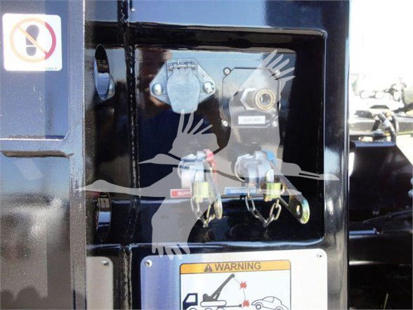 Freightliner M2 106 equipment panel showing two hydraulic/coupler fittings and warning label near controls.