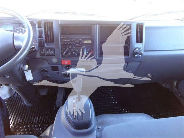 Isuzu NRR truck interior dashboard and gear shifter visible in cabin