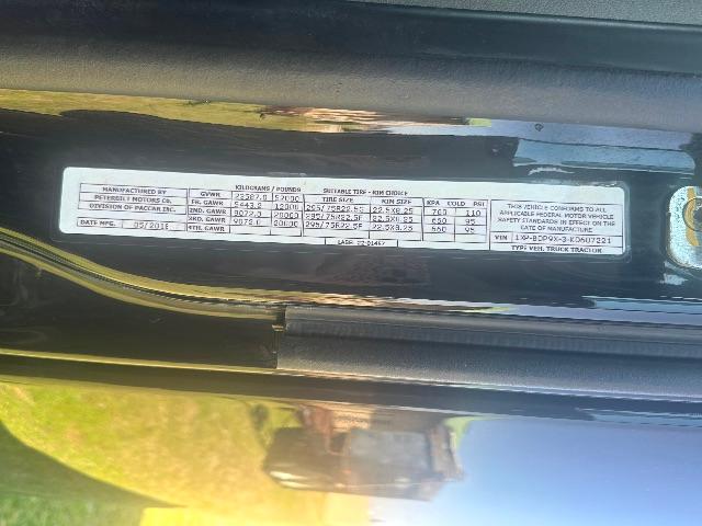 Peterbilt 579 VIN label inside door jamb showing weight ratings and tire information text.