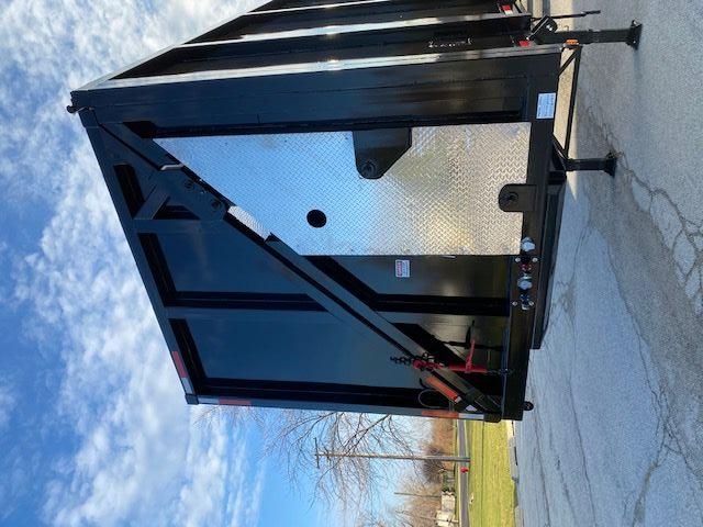 Crush car carrier trailer back end with diamond plate access panel and hydraulic components, black steel frame, 48 ft trailer.