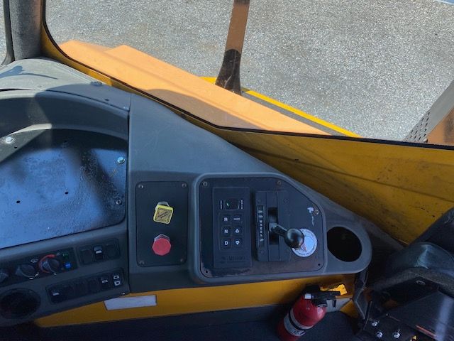 Ottawa T2 truck cab interior dashboard with joystick-like gear selector and control panel.
