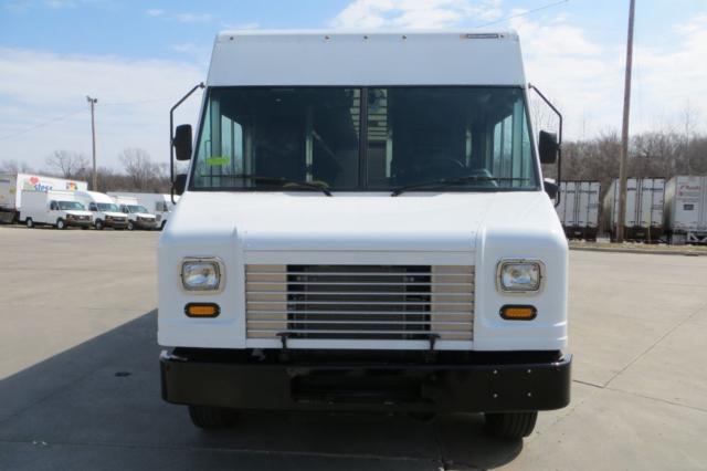 Front view of a white 2015 Ford F59 step van showing grille, headlights, and bumper; stock number New11120 in a used inventory setting.