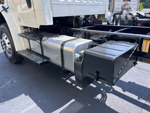 Truck side view showing fuel tank and auxiliary toolbox mounted under cab with steps and chassis.