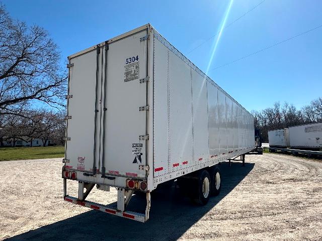 Trailer rear and side view of a white 2015 Wabash DuraPlate dry van trailer with doors closed, stock number H-153, VIN 1JJV532D5FL840508.