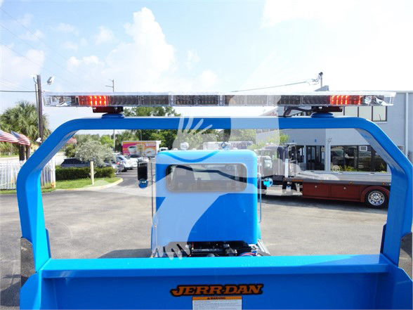Tow truck rear view showing blue frame and a light bar on top; Jerr-Dan logo on the lower rear panel.