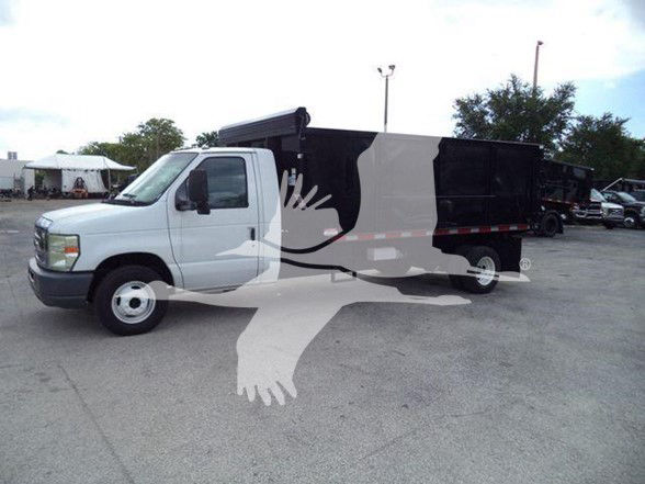 Ford E450 dump truck in light gray cab with black dump body, side view, stock photo with watermark overlay.