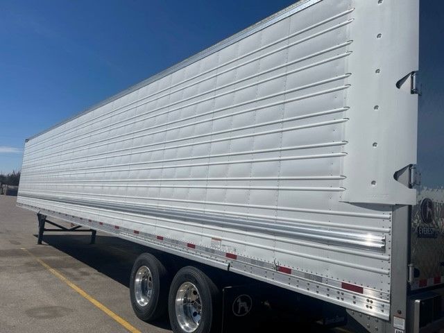 Great Dane 53' x 102" Disc Brake reefer trailer side view, white exterior with ribbed panels and dual rear axles