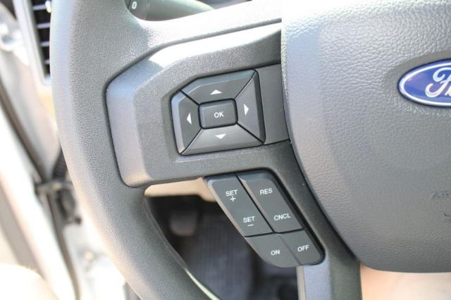 Ford steering wheel with control cluster showing OK button and arrows, plus cruise control buttons labeled SET, RES, CNCL, ON, OFF.