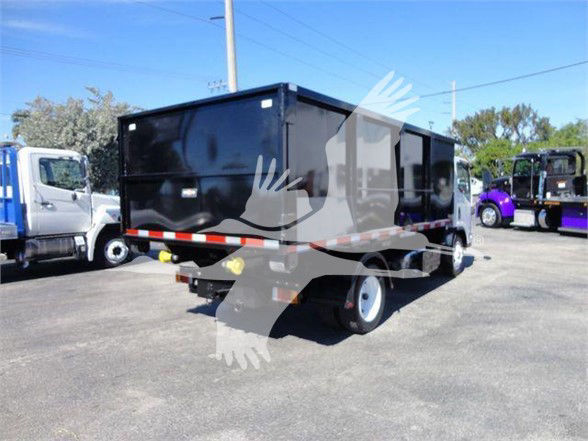 Isuzu NRR dump truck in black with reflective stripes and storage box, side view showing rear cargo area and white wheels.
