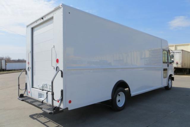 Ford F59 box truck with rear ramp door and side panel in a parking lot.