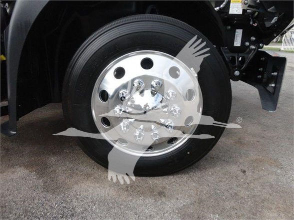 Mack MD6 wheel and tire assembly showing polished aluminum hub with multiple lug nut holes.