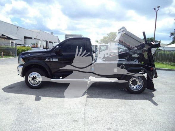2018 Ram 4500 SLT tow truck with dump bed raised, side view showing RAM 4500 badge on front door area.
