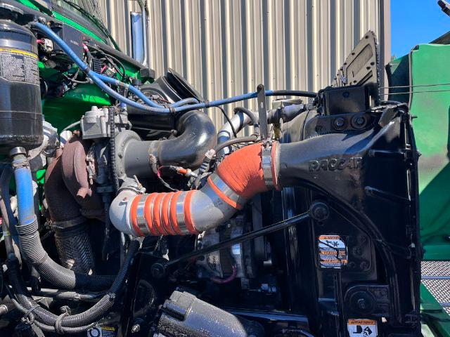 Trucking engine bay of a 2016 Peterbilt 348 showing turbocharger piping and RACCAR/Packard components with hoses and dampers.