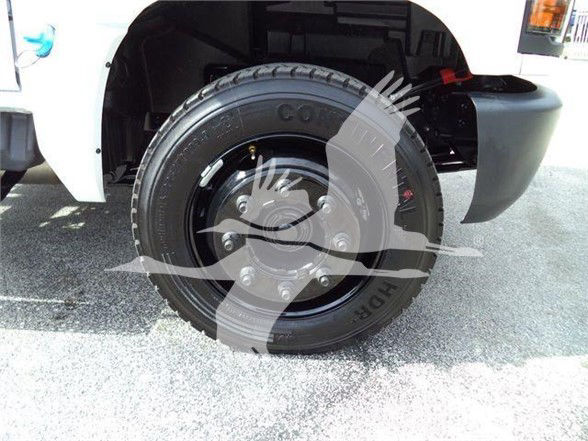 Front wheel of a CH Silverado 6500HD showing Goodyear tire and steel rim with lug nuts, wheel well and part of fender.