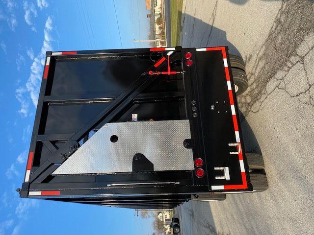Transcraft 48 ft crushed car carrier trailer rear view showing black paint, diamond plate panel, red and white safety reflectors, and taillights.