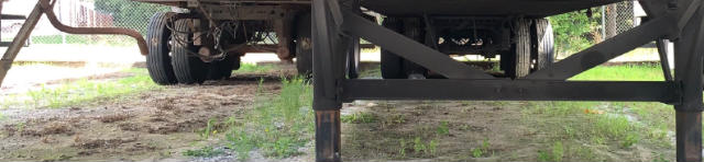 Vanguard VXP trailer undercarriage showing suspension, axles, and frame with support legs