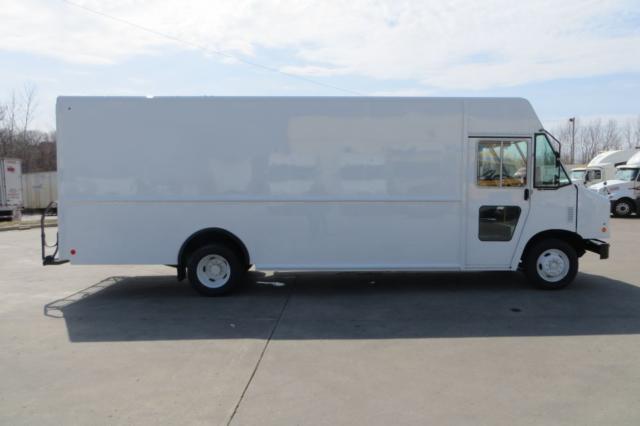 Side view of a white box truck (2015 Ford F59) with no visible logos, large cargo area, cab-forward design.