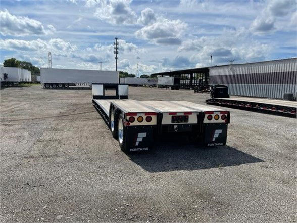 Fontaine Renegade 18 LX40 trailer rear view showing dual axle, rear lights, and Fontaine branding on mudflaps.