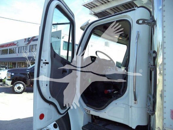 2016 Freightliner M2 106 business class truck cab interior with open door showing entry and dashboard area