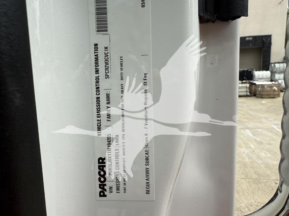 Truck component label showing PACCAR Vehicle Emission Control Information and VIN-related data. Text includes PACCAR, Vehicle Emission Control Information, City, and other control info on a white label.