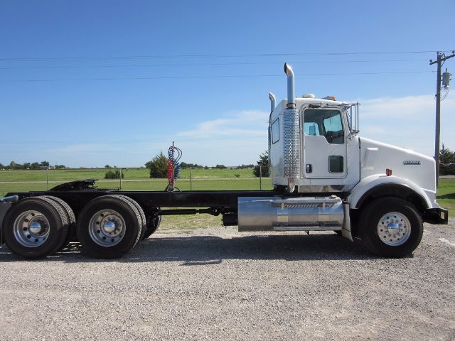 Kenworth T800 conventional daycab truck side view showing chassis and cab with chrome fuel tank and exhaust stack.