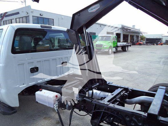 Ford F550 dump truck front cab and hydraulic crane attachment with engine bay exposed