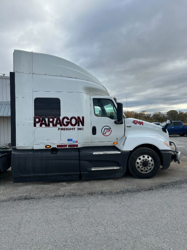 2019 International LT625 sleeper truck cab side with Paragon Freight Inc branding and 4x4 badge.