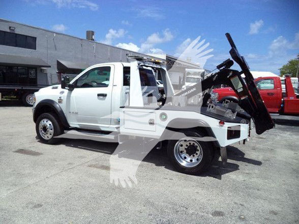 Ram 4500 tow truck side view showing service bed and hydraulic lift.