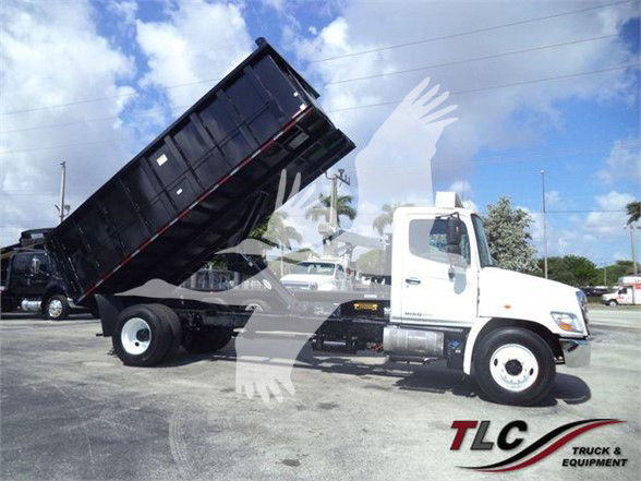2016 Hino 268A dump truck with bed raised, side view showing cab and chassis.