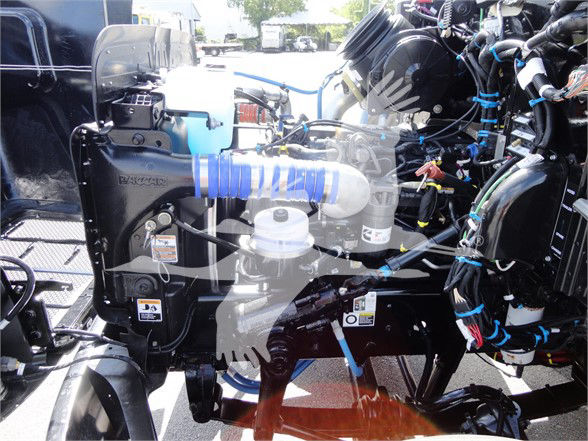 Peterbilt 337 engine bay showing coolant reservoir and various hoses and wiring.