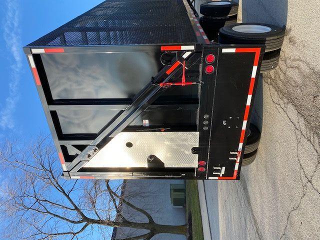 Back of 2008 Transcraft 48 ft crush car carrier trailer with black paint, diamond plate access panel, and rear loading ramp.