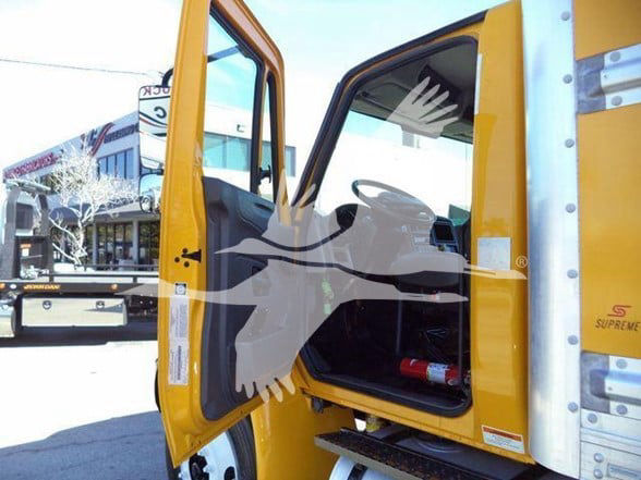 Cab interior of a 2019 International DURASTAR 4300 truck with open driver-side door, showing steering wheel and seat.