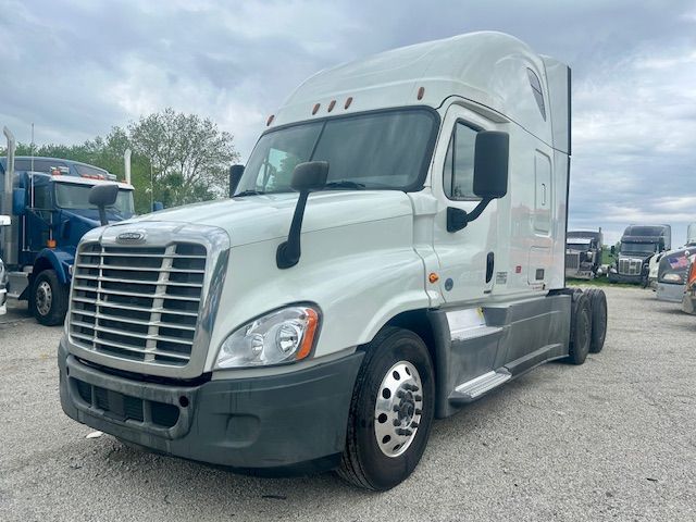 2019 Freightliner Cascadia 125 tractor unit in light color with sleeper, front grille, large side mirrors. Visible text on badges and doors not legible.