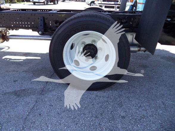 Wheel and chassis of a Isuzu NPR HD truck showing white steel wheel and tire mounted on a truck frame.