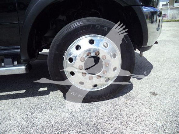 Ram 4500 wheel and tire assembly showing chrome polished hub with lug bolts and tire tread in a truck's fender area.