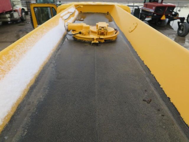 Truck battery area showing yellow hopper with top hatch and black surface.