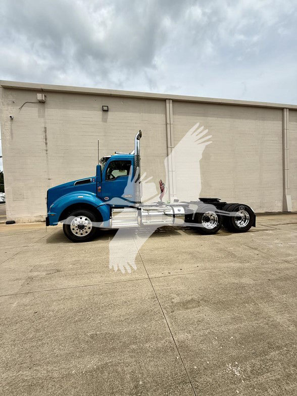 Kenworth T880 semi truck in blue with chrome fuel tanks and exhaust stack, side view showing cab and chassis, no trailer attached.