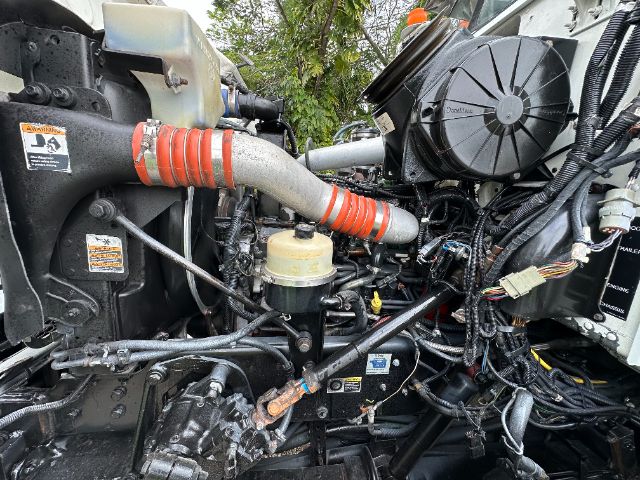  peterbilt 340 engine bay showing coolant reservoir and various hoses and wiring