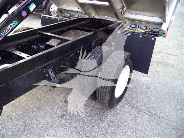 Isuzu NPR HD dump truck chassis visible with rear wheel, frame rails, and hydraulic components. Some stickers along frame show partial text.