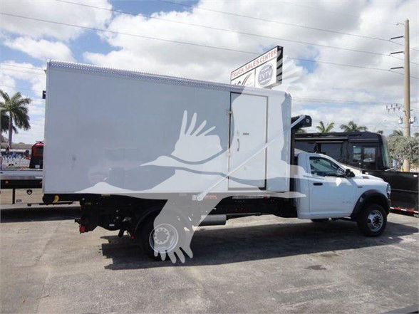 Ram 5500 HD refuse truck with white cab and large box body viewed from side; no legible text visible on the vehicle itself.