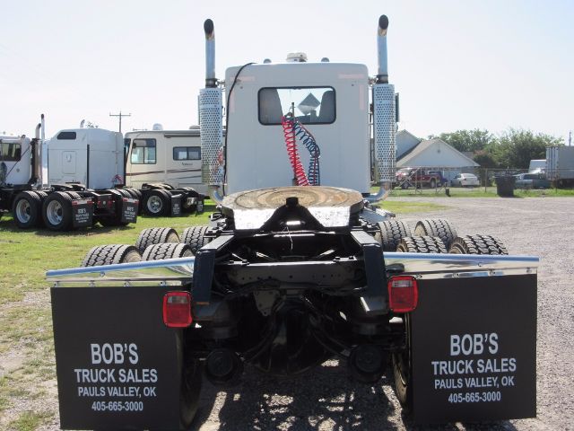 Rear view of a 2005 Kenworth T800 tractor with dual mud flaps reading 'BOB'S TRUCK SALES' and a visible fifth wheel.