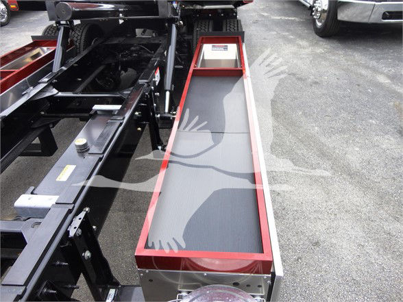 Peterbilt 337 truck chassis with a red-framed step platform/step ladder and black surface, showing a long rectangular side box.