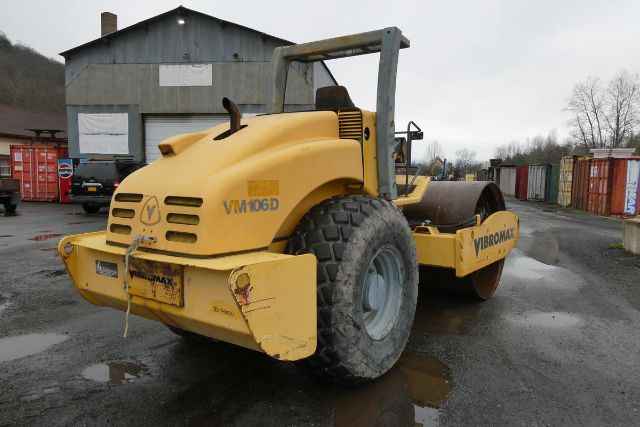 Vibromax VM106D soil compactor/truck-like roller showing large rear wheel and front drum, yellow paint, stock number 0410241.
