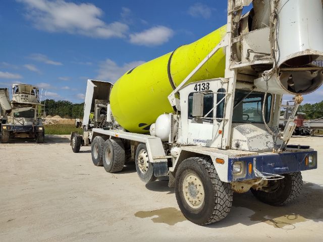 Terex FDB5000 cement mixer truck with yellow drum and white chassis, number 4133 on cab, dirt and wear.