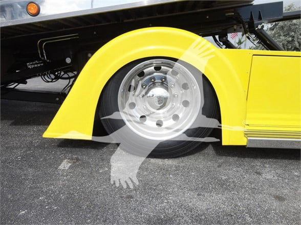 Peterbilt 337 wheel and yellow fender half-view showing wheel and part of side panel.